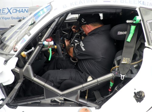 Team mechanic Matt Sheffield affixes my powerful magnet to the #33 safety net. A steel washer affixed to the seatbelt allows drivers to toss the belt aside quickly to land in a specific position for quick retrieval. I also worked on Matt, a former nationally ranked BMX racer.